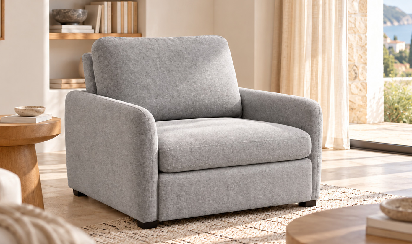 Gray fabric accent chair with plush cushions in a bright, sunlit living room